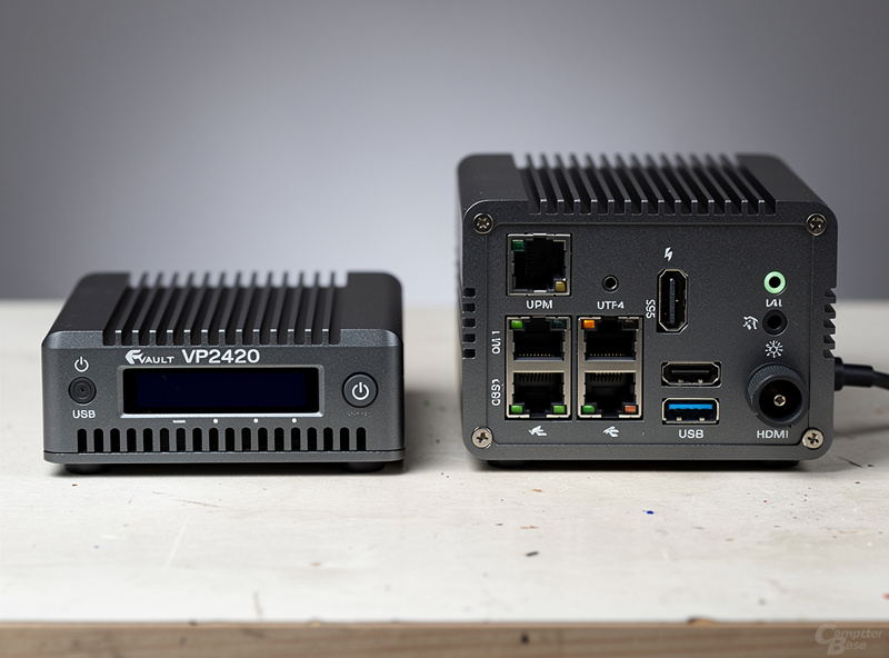 Protectli Vault VP2420 mini PC mounted on a homelab rack with four Ethernet cables connected to the back panel and status lights illuminated