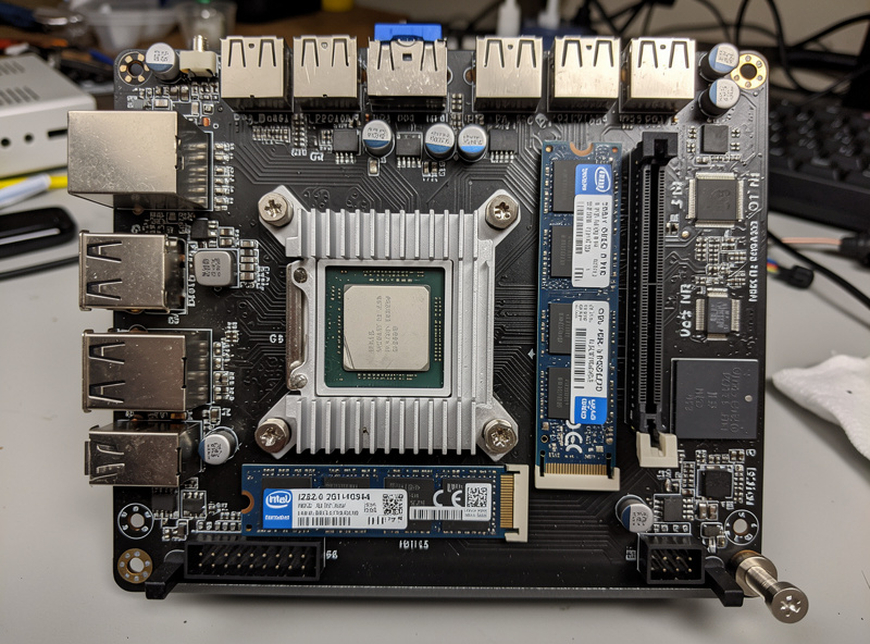 Internal view of an opened Protectli Vault VP2420 showing the Intel CPU heatsink Intel i226-V NIC chips DDR5 RAM modules and NVMe SSD on the motherboard