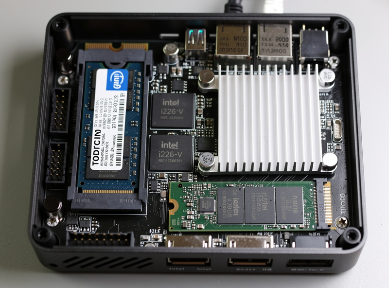 Internal view of an opened Topton N100 mini PC showing the Intel N100 CPU heatsink Intel i226-V NIC chips and DDR5 RAM module installed on the motherboard