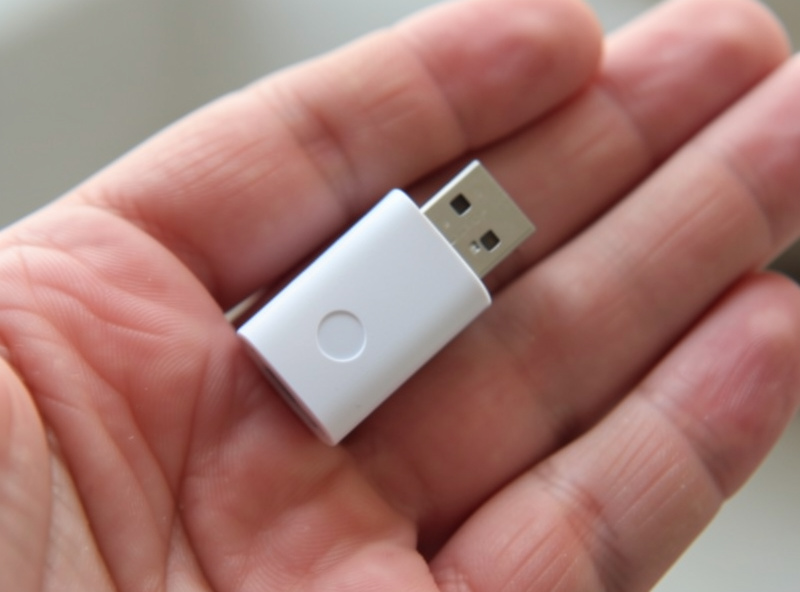 Google Coral USB accelerator held in hand showing its small size