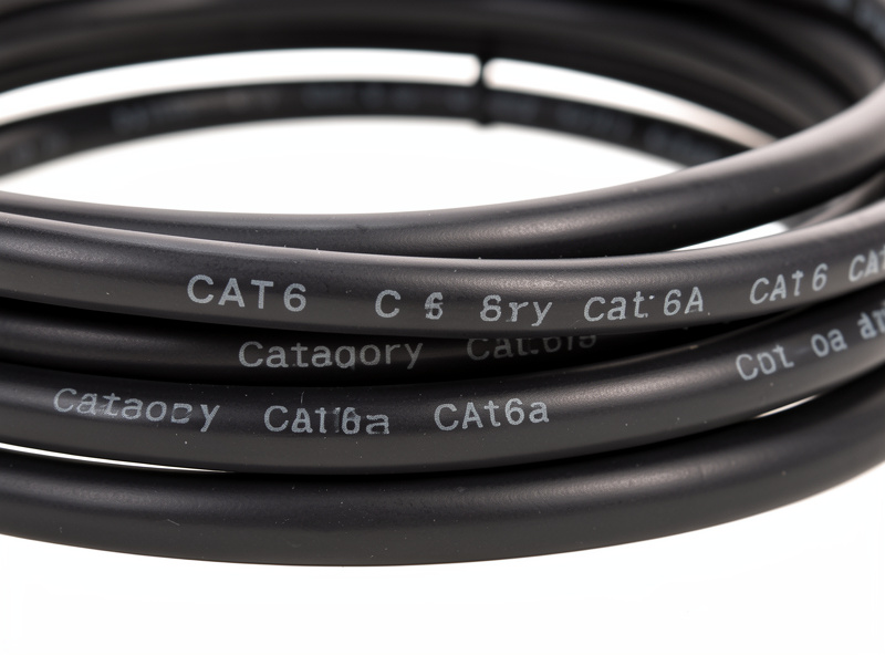 Coiled Cat6 and Cat6a ethernet cables with category markings on the jacket
